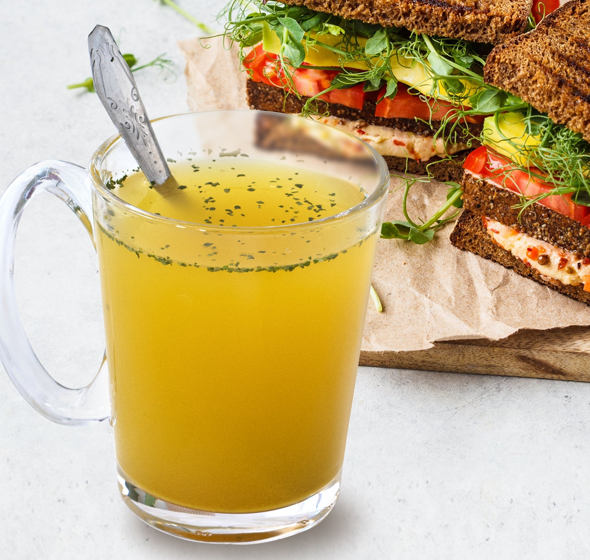 Cup of Moong Pani Golden broth with a sandwich